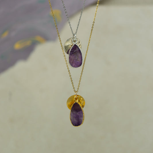 raw purple amethyst teardrop pear shaped pendant with small back disk on a chain in gold and silver.