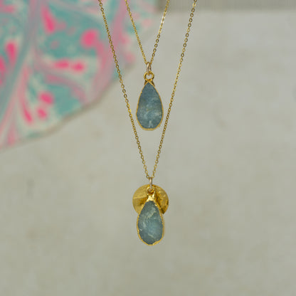 Raw blue Aquamarine teardrop pear shaped pendants finished in gold on a chains.