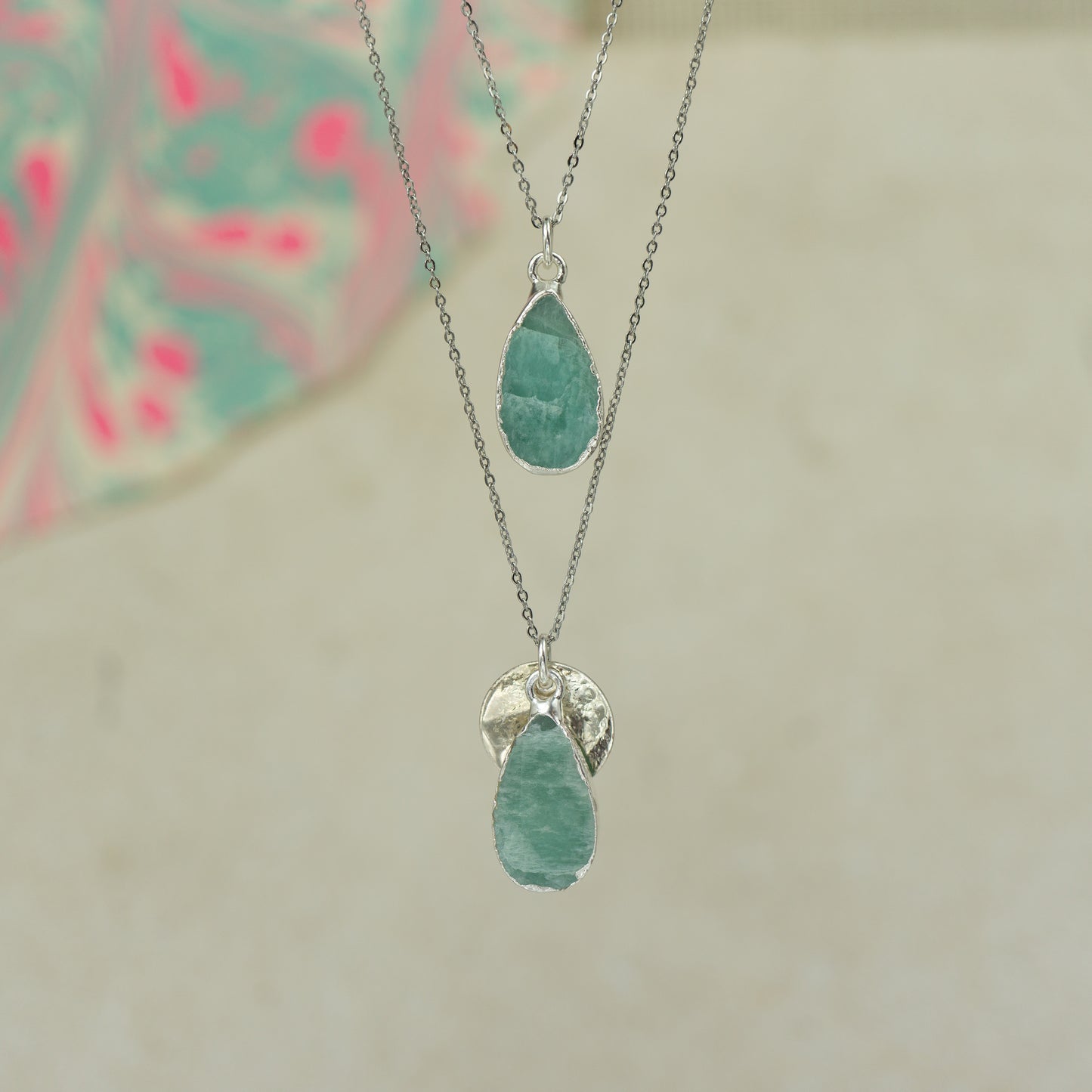 Raw blue Aquamarine teardrop pear shaped pendants finished in silver on a chains.