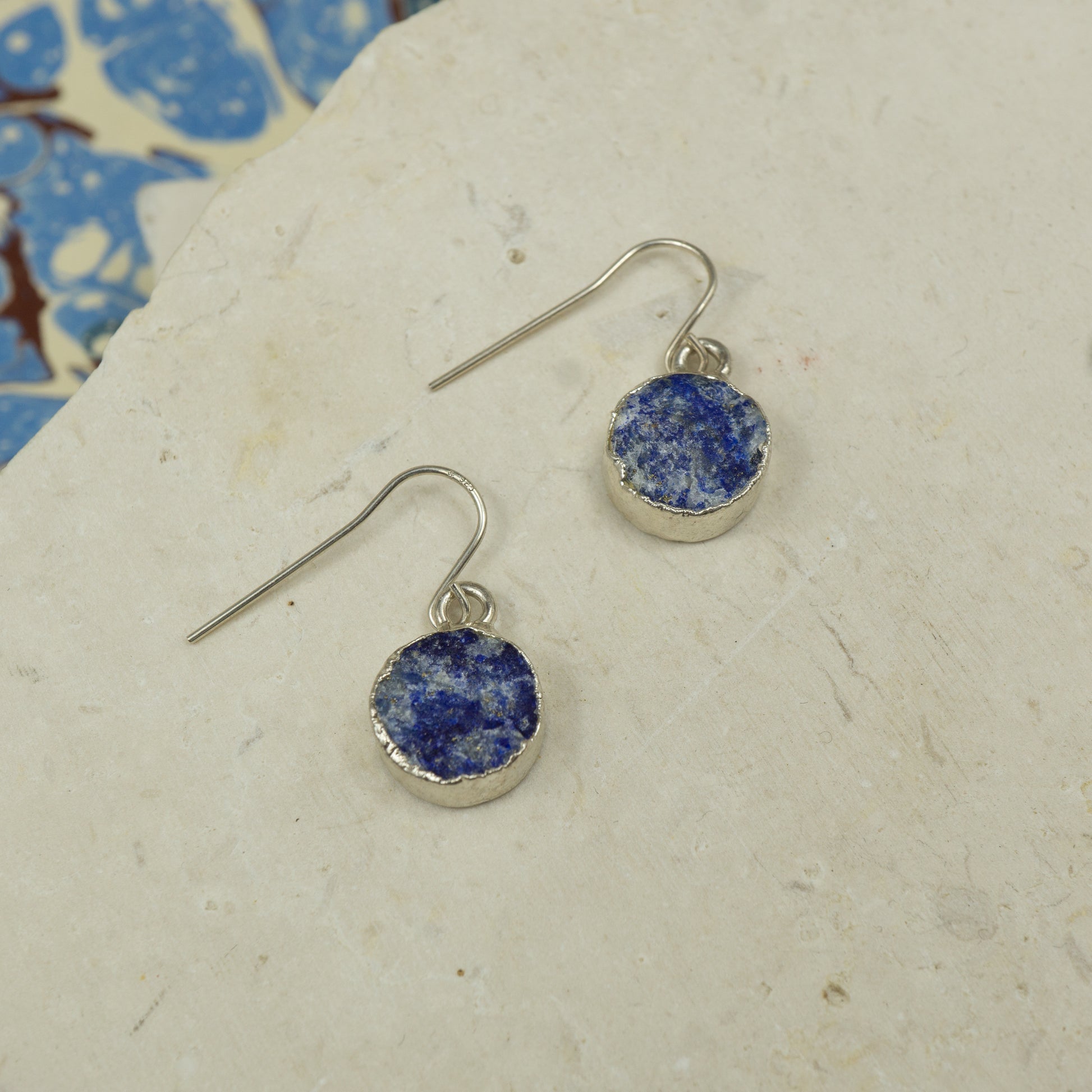 Round raw Blue Lapis Lazuli earrings on hooks finished in Silver..