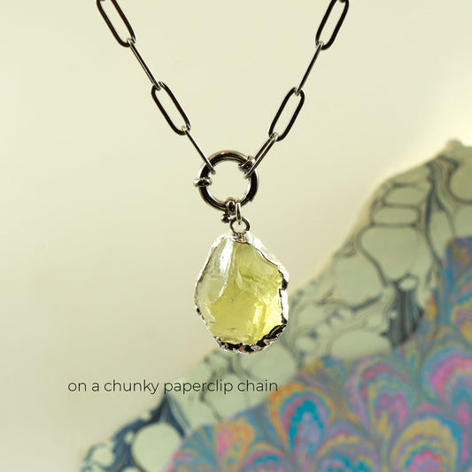 A necklace with a chunky paperclip chain and a faceted pale yellow Lemon Quartz gemstone pendant