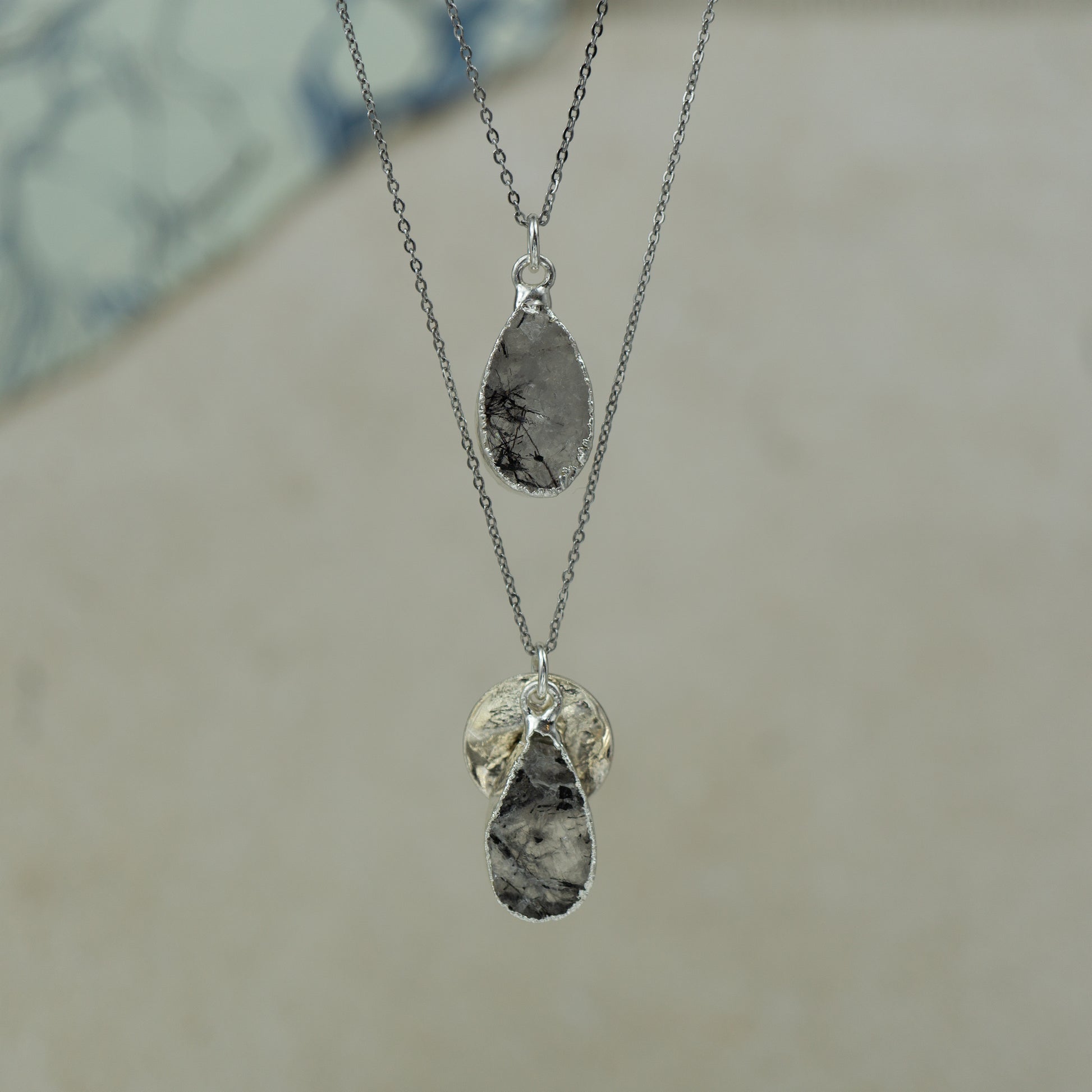 raw white rutilated quartz teardrop pear shaped pendants finished in silver on a chains