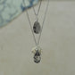 raw white rutilated quartz teardrop pear shaped pendants finished in silver on a chains