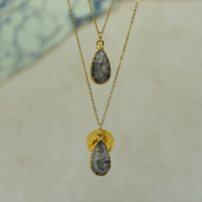 raw white rutilated quartz teardrop pear shaped pendants finished in gold on a chains