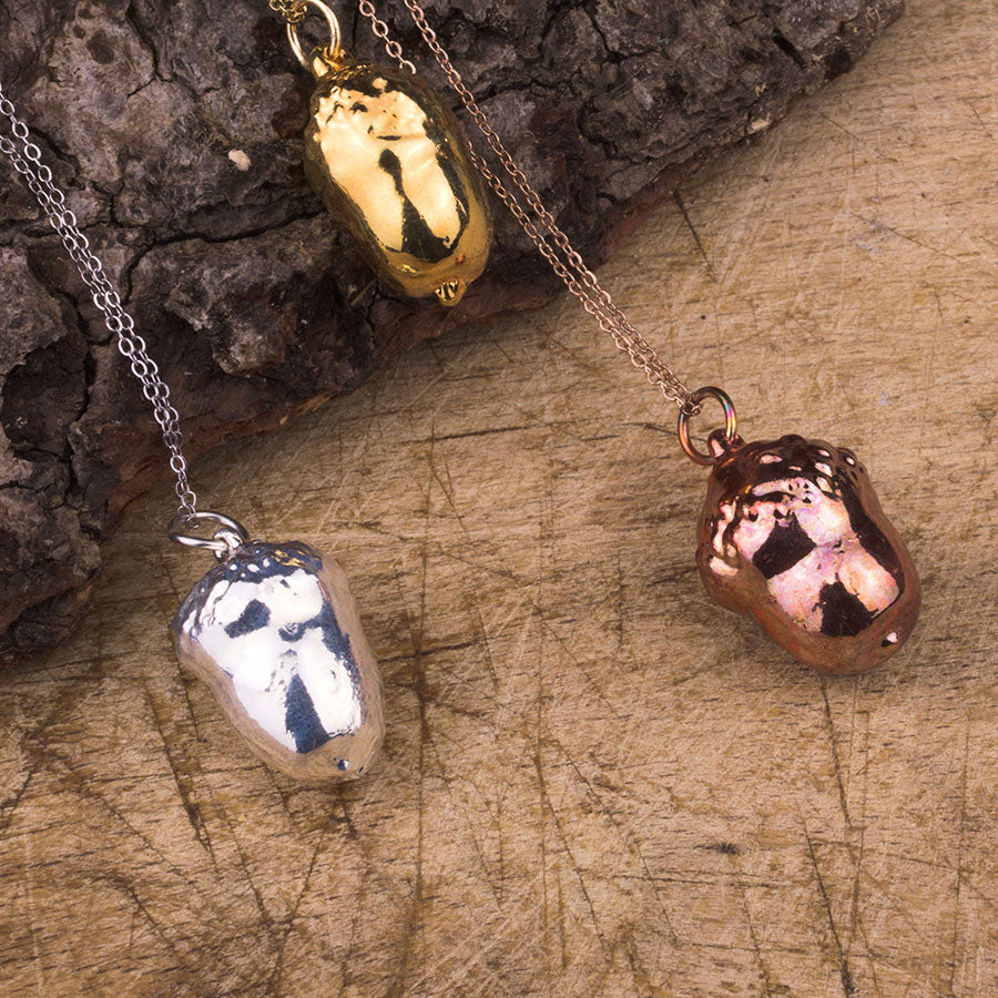 real acorn pendant in gold, silver and rose gold on a chain