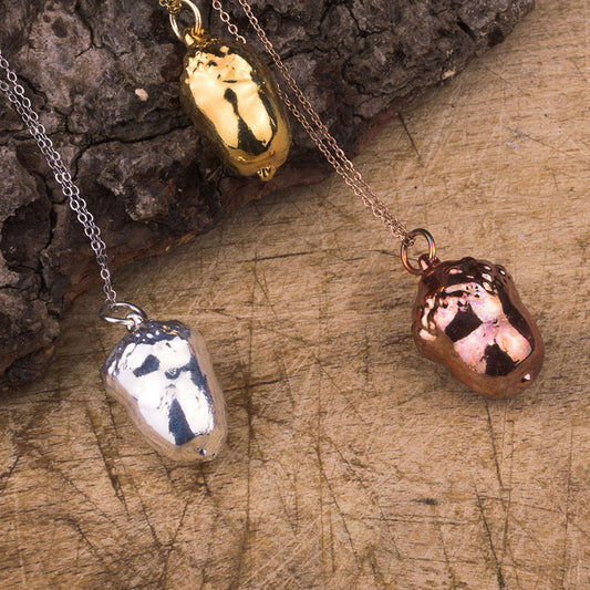 real acorn pendant in gold, silver and rose gold on a chain