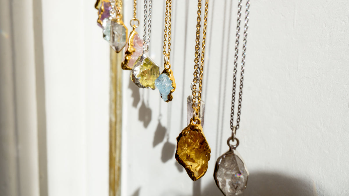 Several raw crystal and gemstone pendants 