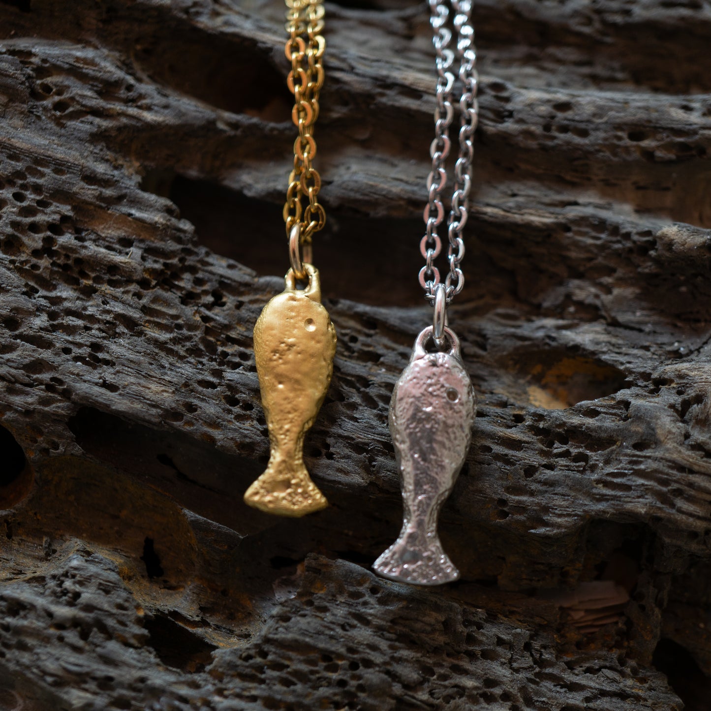 A gold and silver textured finished fish charm 