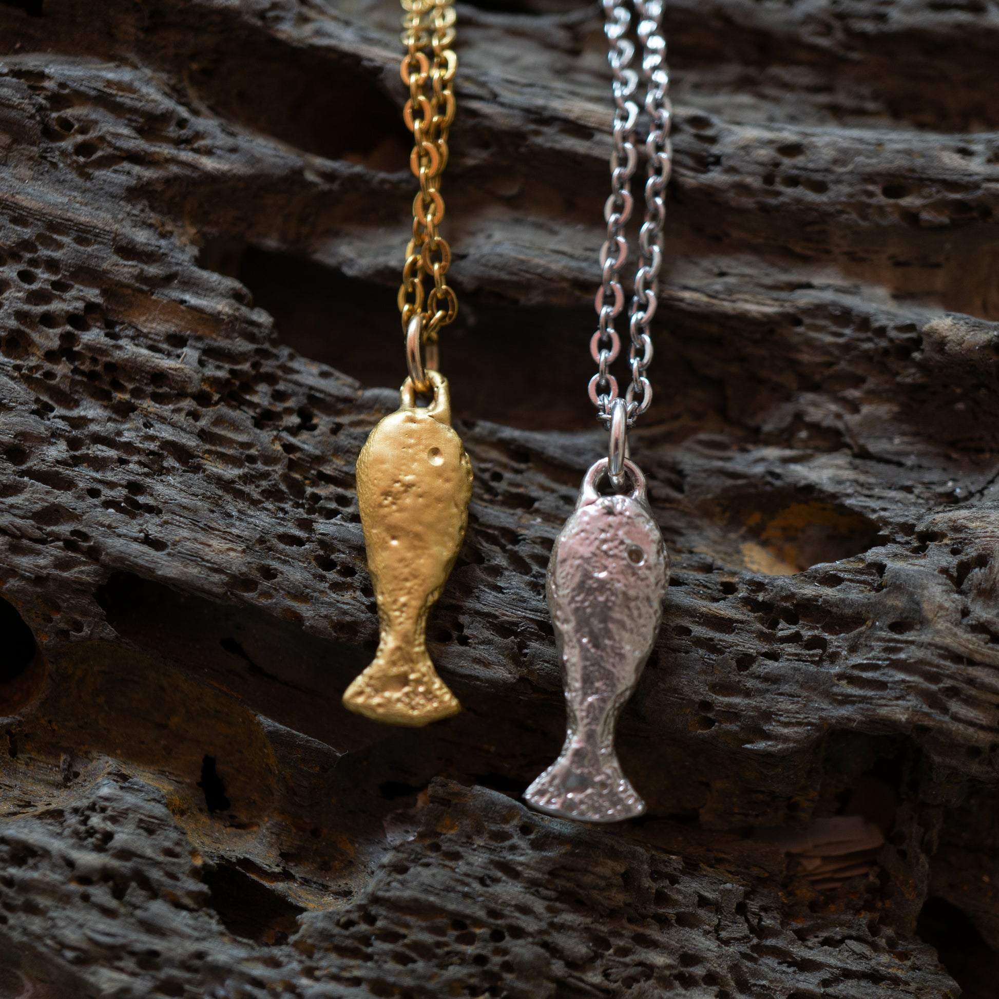 A gold and silver textured finished fish charm 