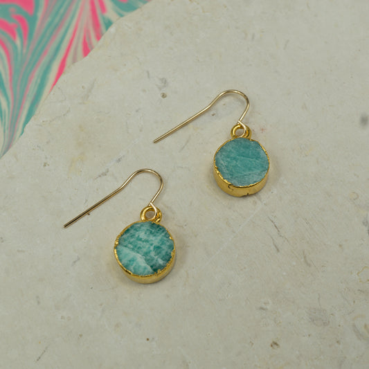 Round raw Blue amazonite earrings on hooks finished in gold.