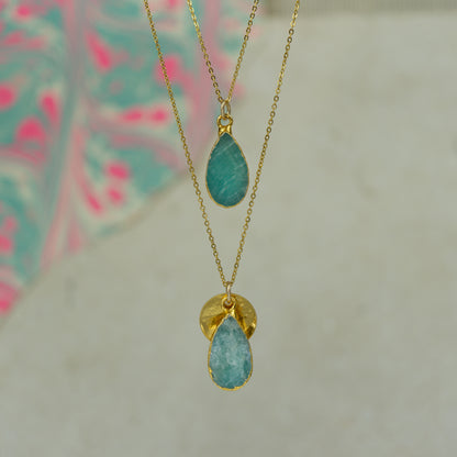 raw blue and green amazonite teardrop pear shaped pendants finished in gold on a chains.