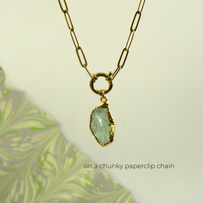 A gold paperclip chain necklace with a raw, irregular light Green Amethyst gemstone pendant
