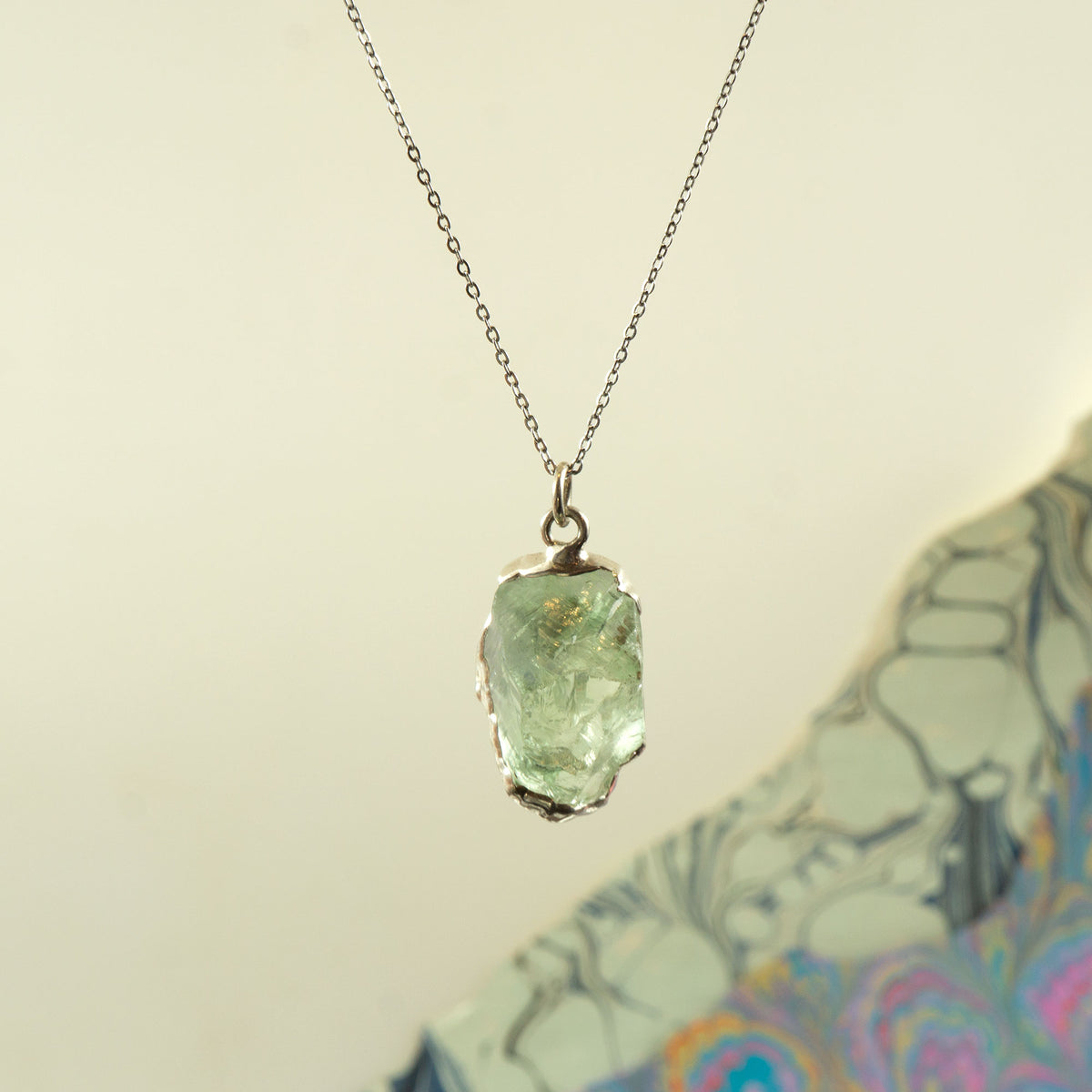A raw Green Amethyst gemstone pendant necklace on a delicate silver chain
