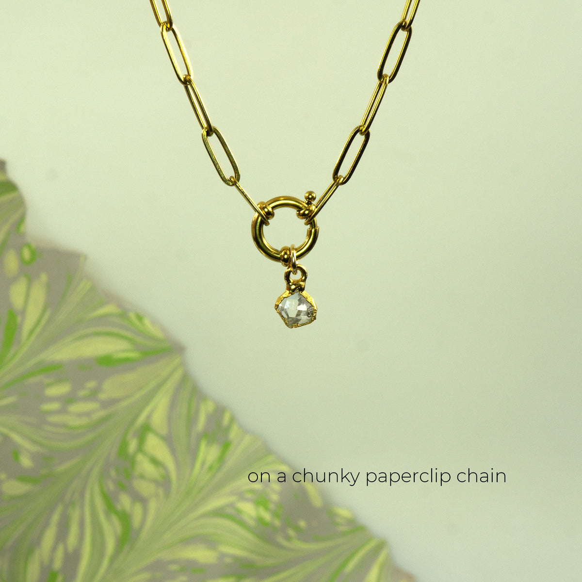 Gold paperclip chain necklace with a small clear faceted herkimer diamond gemstone pendant