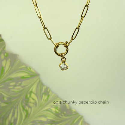 Gold paperclip chain necklace with a small clear faceted herkimer diamond gemstone pendant