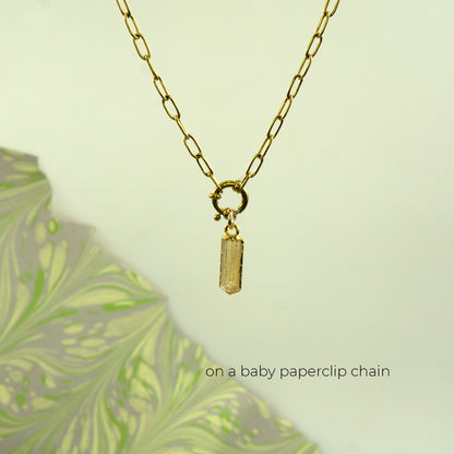 A gold paperclip chain necklace with a small rectangular gold Imperial Topaz pendant.