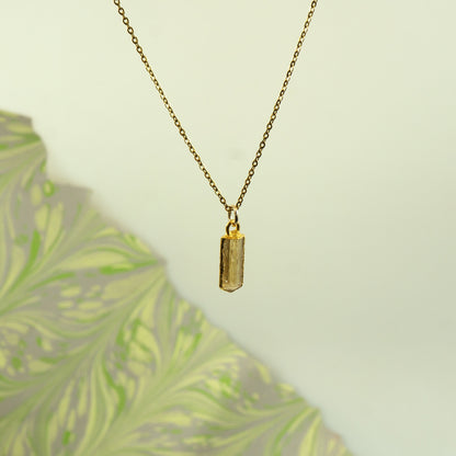 A gold chain necklace with a small rectangular faceted crystal Imperial Topaz pendant