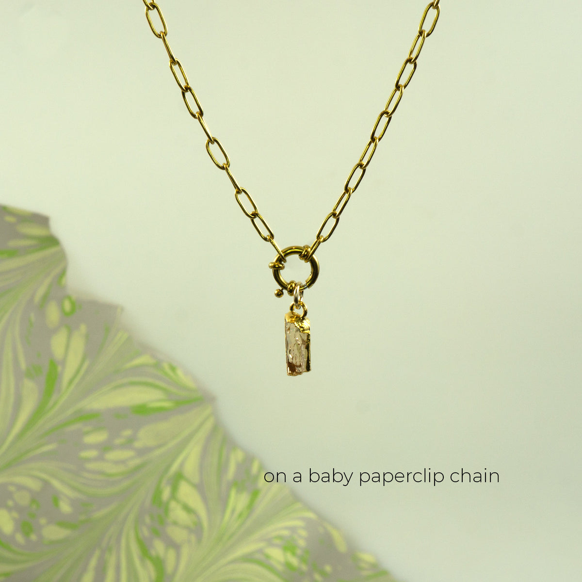 Gold baby paperclip chain necklace with a ring clasp and a rectangular Imperial Topaz gemstone pendant.
