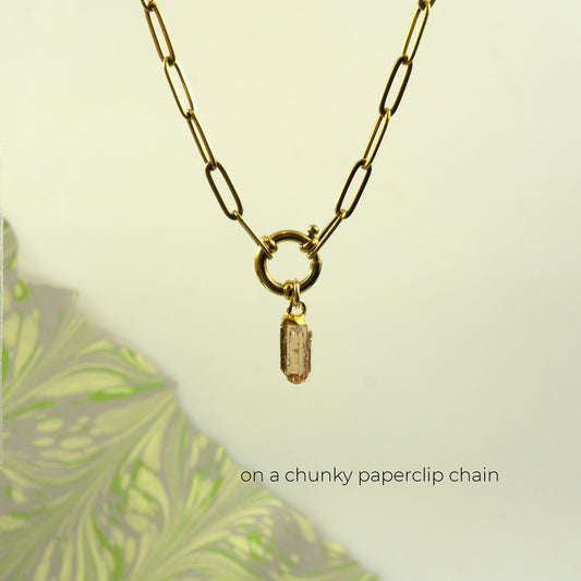 Gold paperclip chain necklace with a ring clasp and a small rectangular Imperial Topaz stone pendant.