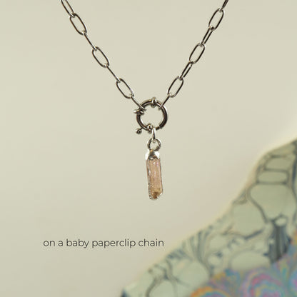 A silver paperclip chain necklace with a small ring clasp and a dangling Imperial Topaz crystal pendant.