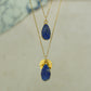 Raw blue Lapis Lazuli teardrop pear shaped pendants finished in gold on a chains.