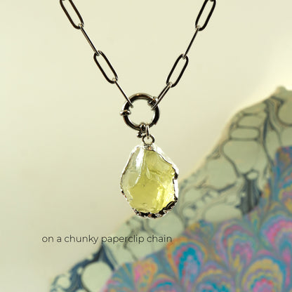 A necklace with a chunky paperclip chain and a faceted pale yellow Lemon Quartz gemstone pendant