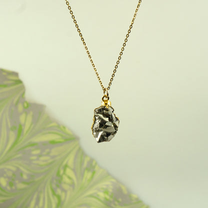 Raw pyrite pendant on a delicate gold-plated chain