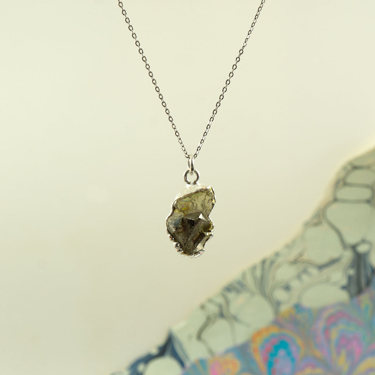 Raw pyrite pendant on a delicate silver chain