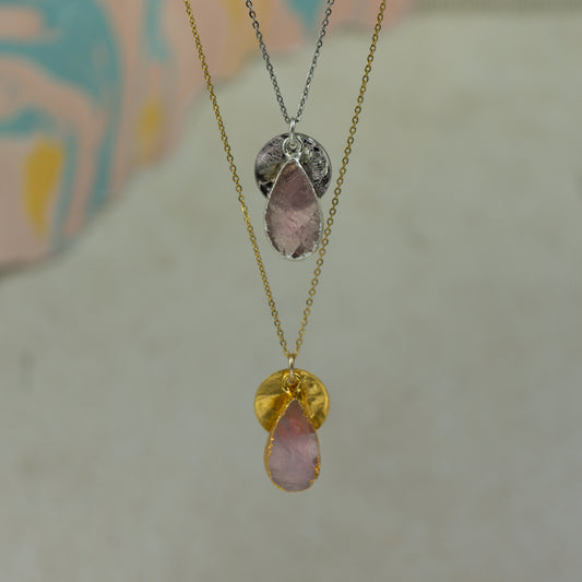 pink rose quartz teardrop pear shaped pendant with small back disk on a chain in gold and silver.