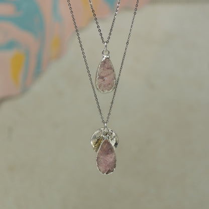 single teardrop pink rose quartz pendants finished in silver on a chains.