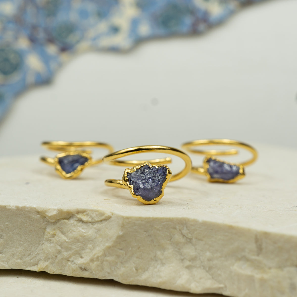 A set of gold corkscrew style rings with small raw Tanzanite stones