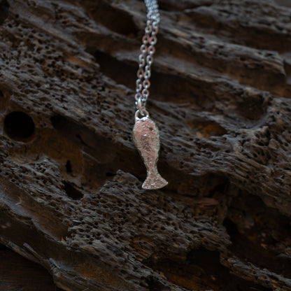 Silver textured fish charm on a chain