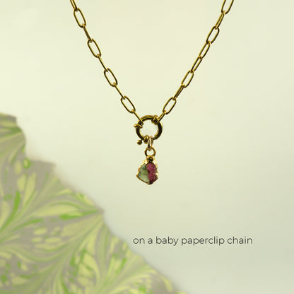 Gold paperclip chain necklace with a small charm featuring a pink and green Watermelon Tourmaline gemstone.