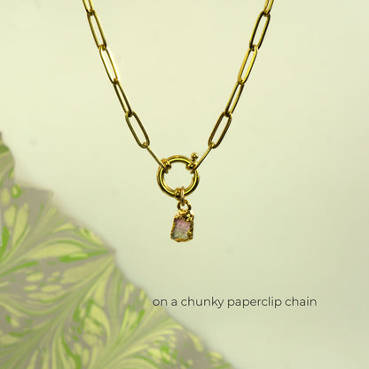 A gold paperclip chain necklace with a small dangling pink and green Watermelon Tourmaline gemstone