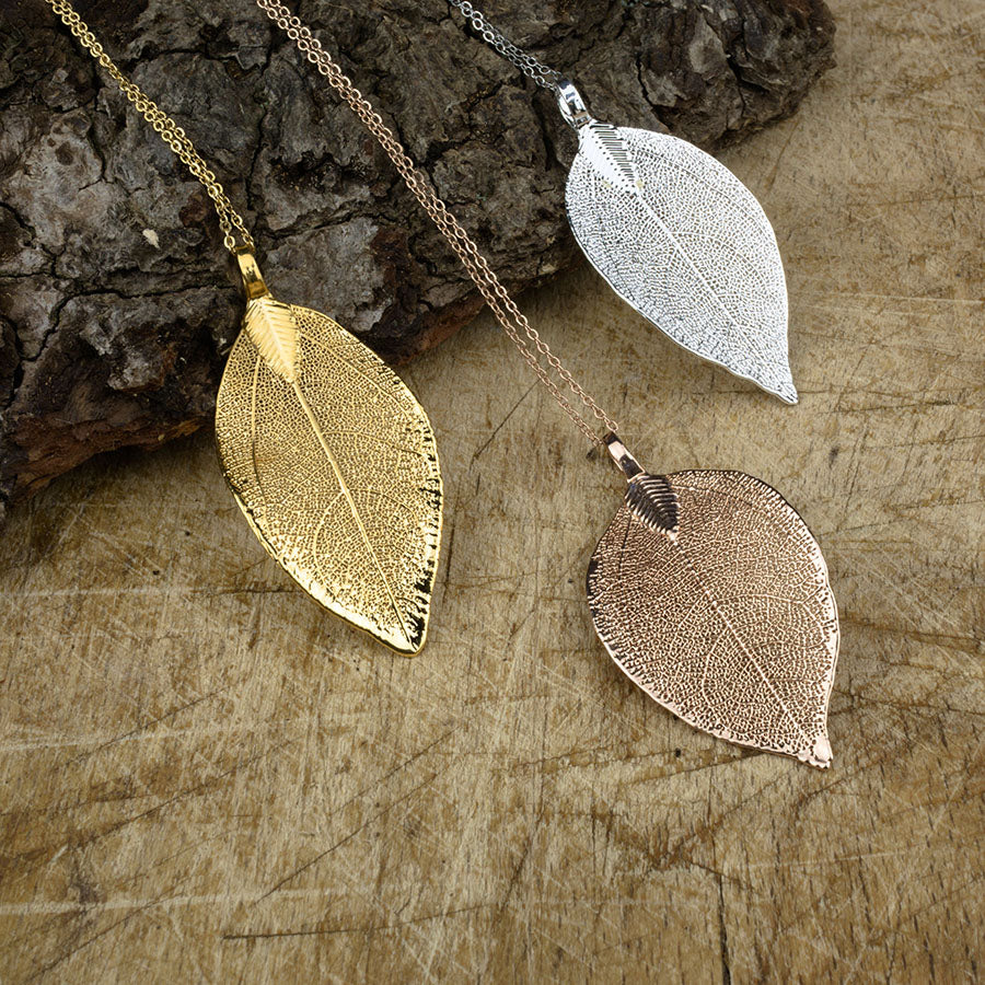 real magnolia leaf pendant in gold, rose gold and silver on chains